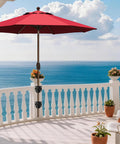 American Made Full Aluminum Non-Rust Deck Umbrella Mount attached to railing on sunny balcony with ocean view, red umbrella.