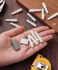 No Hassle Fixin Up Kit For Plantation Shutters featuring steel spring pins, louver staples, and collar pins in hand.