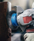 Badass Torque 120 Volt 10 Amp X Lock Mount 4 1/2 Inch Corded Angle Grinder cutting rusty metal with a blue disc.