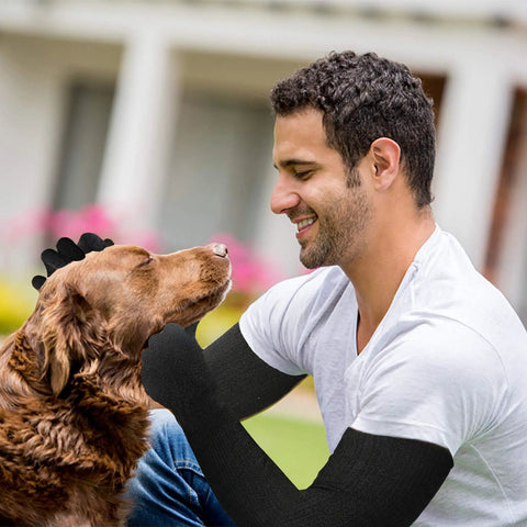 Man wearing Kevlar Gloves With Sleeves Level Five Cut And Heat Resistant Safety Gear petting a dog.