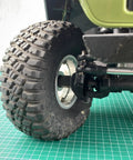 Steel Hex Wheel Spacers Plus Twenty Mm Extended For Axial Scx6 One Sixth Scale Rc Crawler Truck close-up of tire and axle assembly