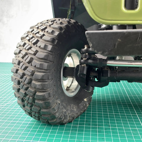 Steel Hex Wheel Spacers Plus Twenty Mm Extended For Axial Scx6 One Sixth Scale Rc Crawler Truck close-up of tire and axle assembly