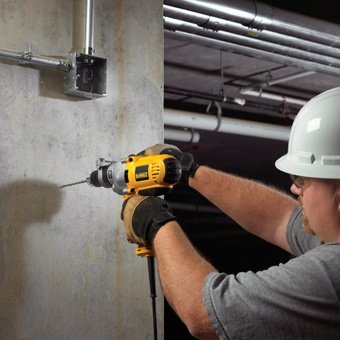 Worker using Corded Hammer Drill Kit With Half Inch Capacity And Ten Amp Power For Masonry Wood And Steel Drilling Dual Mode Hammer And Drill Built For Pros And Serious DIYers Who Need Beefy Power on concrete wall