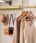 Knockout Twelve Inch Retractable Closet Pull Out Rod Featuring Five Heavy Gauge Steel Rings For Zero Fuss Hangin Of Belts And Accessories handles handbags and clothes in polished gold finish.