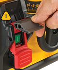 Close-up of Compact Jobsite Table Saw power switch with safety cover, highlighting smooth operation and red button for quick access.