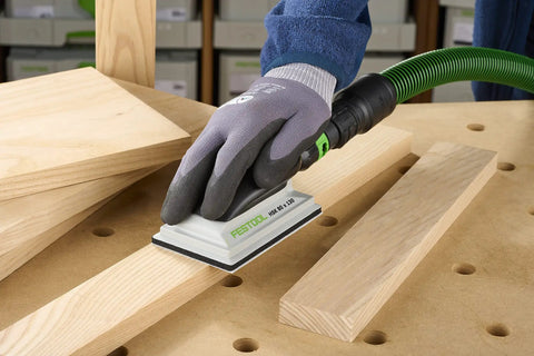 Using Ergonomic Hand Sanding Block With Easy Grip Handle And Suction Bypass For Precise 80 mm By 133 mm Sandpaper on wood