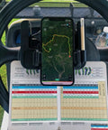Rock Solid Golf Cart Phone Holder Steering Wheel Mount holding phone with map above scorecard on cart steering wheel.