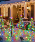 Lit RGB LED Christmas Cone Trees with App Control in snowy yard, showcasing color changing light show for holiday decor