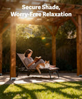 Person reading on a lounge chair under a wooden pergola in a garden, with a cat lying on the chair.