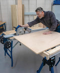 Level Up Your Shop Rig With These Knockout Adaptive Cutting System Extension Brackets That Bolt Right Onto Standard Workbenches Or Portable Project Tables For Quick Setup, worker using track saw on plywood.