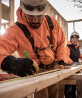 Construction worker wearing Men's Insulated Water-Resistant Leather Palm Winter Work Gloves With Goat Skin Palm in large size.