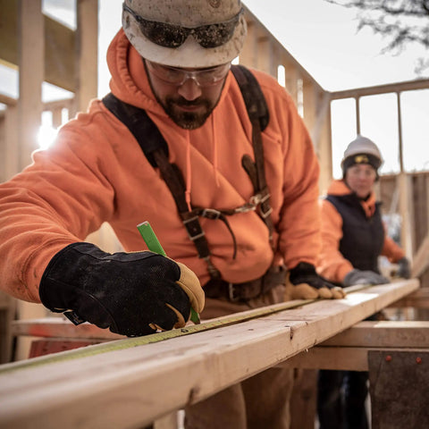 Construction worker wearing Men's Insulated Water-Resistant Leather Palm Winter Work Gloves With Goat Skin Palm in large size.