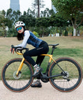 Cyclist on a yellow bike with Carbon Disc Brake Wheelset 50mm Deep Tubeless Rim, in a park setting