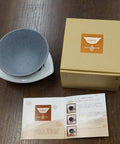 Japanese Ceramic Coffee Filter With Reusable Blue Dripper Stand And Eco Friendly Micropore Design For A Smooth Next Level Pour Over Brew That Truly Hits Different with grey screen and box.