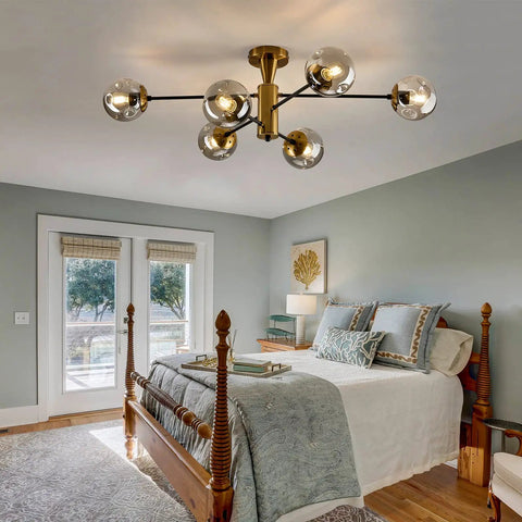 6-Light Sputnik Gold Ceiling Light Fixture With Glass Globe in bedroom, exhibiting mid-century chandelier style