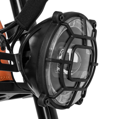 Close-up of the headlight on an Adult Electric Bike In Sleek Black With Sturdy Cargo Rack Featuring Zippy Motor Pedal Assist.