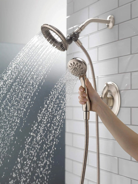 Linden 17 Series Dual Function Shower Trim Kit with 4-Spray In2ition 2-In-1 handheld shower head and hose in use, stainless steel