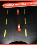 4 Pack 18 Inch Traffic Safety Cones With Heavy Duty Black Weighted Base placed on road, reflective orange PVC cones.