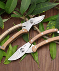 Two Workhorse Wood Handle Pruning Shears With SK-5 Blade For Clean, Crisp Cuts, 1 Inch Cutting Capacity displayed on leaves