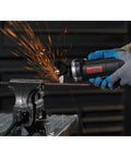 Three Inch Electric Cutoff Tool With Six Amp Motor in use cutting metal pipe, emitting sparks, tool held in gloved hands