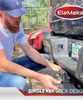 Person installing EleMake trailer hitch lock onto vehicle's tow receiver, demonstrating single key lock design for security.