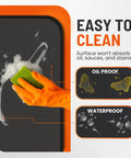 Gloved hand cleaning Heavy Duty 48x30 Inch Under Grill Mat For Deck And Patio, Double Sided Grill Protector For Outdoor Cooking.