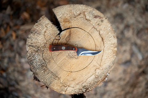 Generational USA Fixed Blade Knife With Three Point Five Inch Clip Point Skinner on a log surface