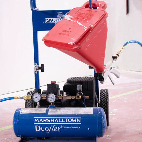SprayMate Drywall Hopper Gun Texture Sprayer With Seven Orifice Sizes for Effortless Wall Texture, attached to blue compressor