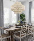 Huge White Rattan Chandelier With 6 Lights Hand Woven 5 Tier Pendant Light above dining table in elegant dining room.