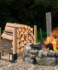 Firewood Log Storage Rack Bracket 4 Pack for Indoor and Outdoor Use holding cut logs next to stone fire pit outdoors