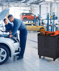 Epic 30 Inch Tool Storage Cabinet with Lockable Rolling Casters and Full Extension Slides for Badass Garage Setup Dope Workshop Gear Chest Heavy Duty Multi Drawer Tool Box Black next to two mechanics working on a car.
