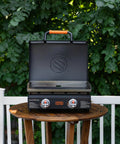 22-Inch Tabletop Griddle With Built-In Hood For Camping And Tailgating on outdoor table