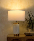 Arden LED Table Lamp With USB Port Charge Your Phone Or Tablet Bedside Reading Light on wooden table with decor