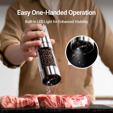 Upgraded Large Capacity Electric Salt And Pepper Grinder Set in use, grinding pepper onto raw meat with LED light and stainless steel finish.
