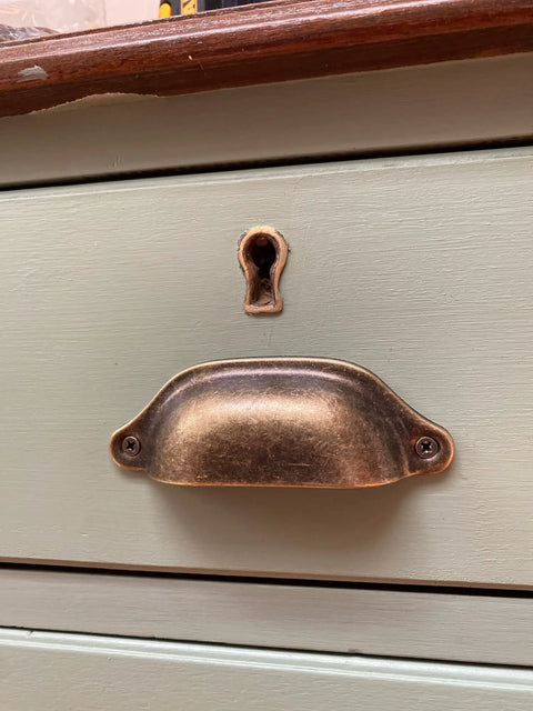 Top Shelf Vintage Shell Cabinet Pulls Slick Red Copper Finish For Kitchen Drawers And Dresser Doors Heavy Duty Iron Build 5 Piece Set For Quick Install Cabinet Hardware With Included Screws on a painted drawer.