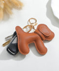 Premium Faux Leather Dog Bag Charm With Sturdy Metal Keyring on keys, featuring brown faux leather puppy design for trendy bags.