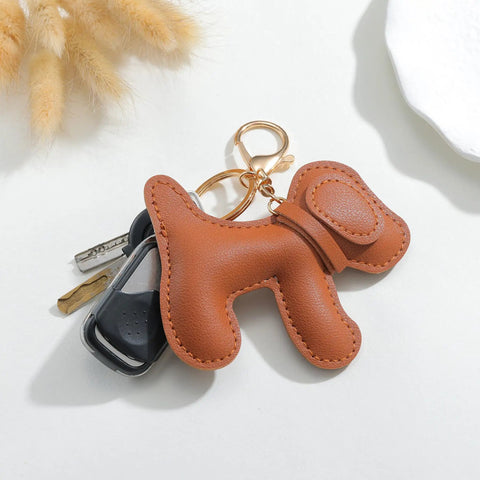 Premium Faux Leather Dog Bag Charm With Sturdy Metal Keyring on keys, featuring brown faux leather puppy design for trendy bags.