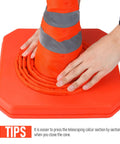 Collapsing orange traffic cone by hand, part of Four Pack 28 Inch Collapsible LED Light Traffic Cones With Reflective Safety Pop Up Design