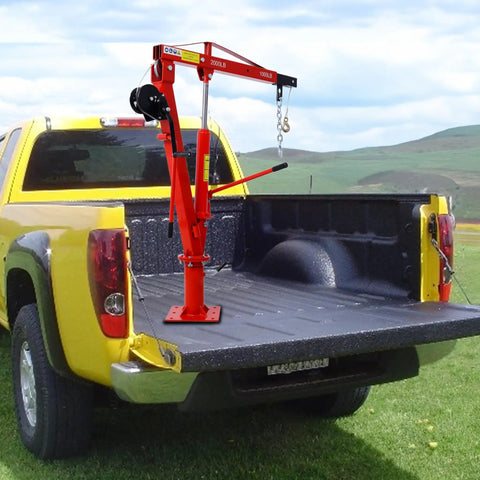 Built Tough Steel Truck Crane and Bed Hoist with Hand Winch for Pickup Trucks in red mounted on a yellow truck bed.