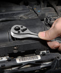 Hand using Quarter Inch Drive Ratchet, 90 Tooth Quick Release, Reversible Wrench, Cr V Steel, Full Polish Finish on an engine