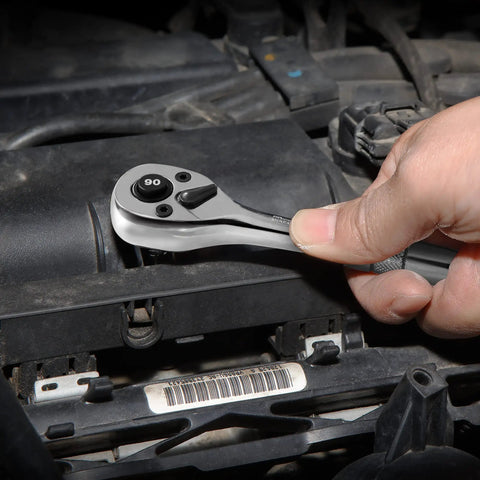 Hand using Quarter Inch Drive Ratchet, 90 Tooth Quick Release, Reversible Wrench, Cr V Steel, Full Polish Finish on an engine