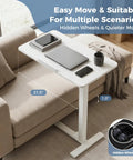 Adjustable Bedside Table With Pneumatic Lift And Hidden Wheels Portable Space Saving Mobile Standing Desk by a sofa