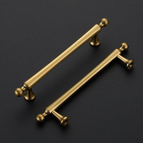 Five Pack Champagne Bronze Cabinet Pulls, 5 Inch Center To Center Kitchen Handles For Cabinets And Dressers, Zinc Alloy, Built To Last Antique Style Hardware For Drawers, Long Lasting Finish And Easy Install. Top view of two champagne bronze cabinet pulls on dark background.