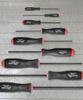 Nine Piece Screwdriver Set With ProGuard Finish, Ergonomic Two Component Handles, Non Slip Grip, Sizes 1.5 to 10 mm on a wooden surface