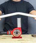 Person using Master-Mite Series Heat Shrink System 220V Red 300 To 500 F Range 1440W Hot Air Tool for bending plastic pipe