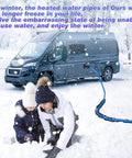 25ft heated RV water hose, blue, attached to a camper van in a snowy scene