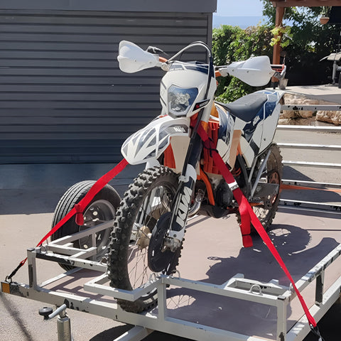 Motorcycle secured with Heavy Duty Cambuckle Straps 1 Inch By 15 Feet 500 Lbs Working Load 1500 Lbs Break Strength Rubber Coated Hooks