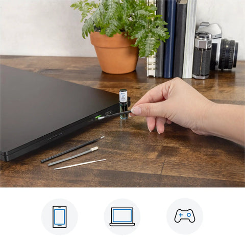 Hand using Phone Laptop Tablet All In One Cleaning Kit With Precision Spudgers Angled Tweezers DeoxIT D100L near a laptop