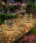 2 Pack Outdoor Solar Lanterns With Hanging Lights Waterproof Metal Sun Moon Star Pattern In Gold Finish on garden table