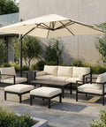 Outdoor patio set with couch, chairs, ottomans, and umbrella in garden setting. Four Pack Outdoor Patio Furniture Clips For Sectional Sofas And Wicker Rattan Chairs, Black 59mm Inner Bore Connectors To Stop Shifting And Fit Garden Furniture Frame Pipes Keeping Your Lounge Clean And Neat not visible.